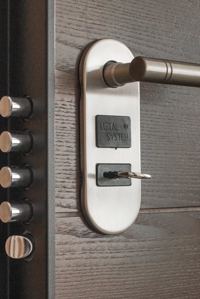 Metal door handle and lock system with key inserted, showcasing security features.